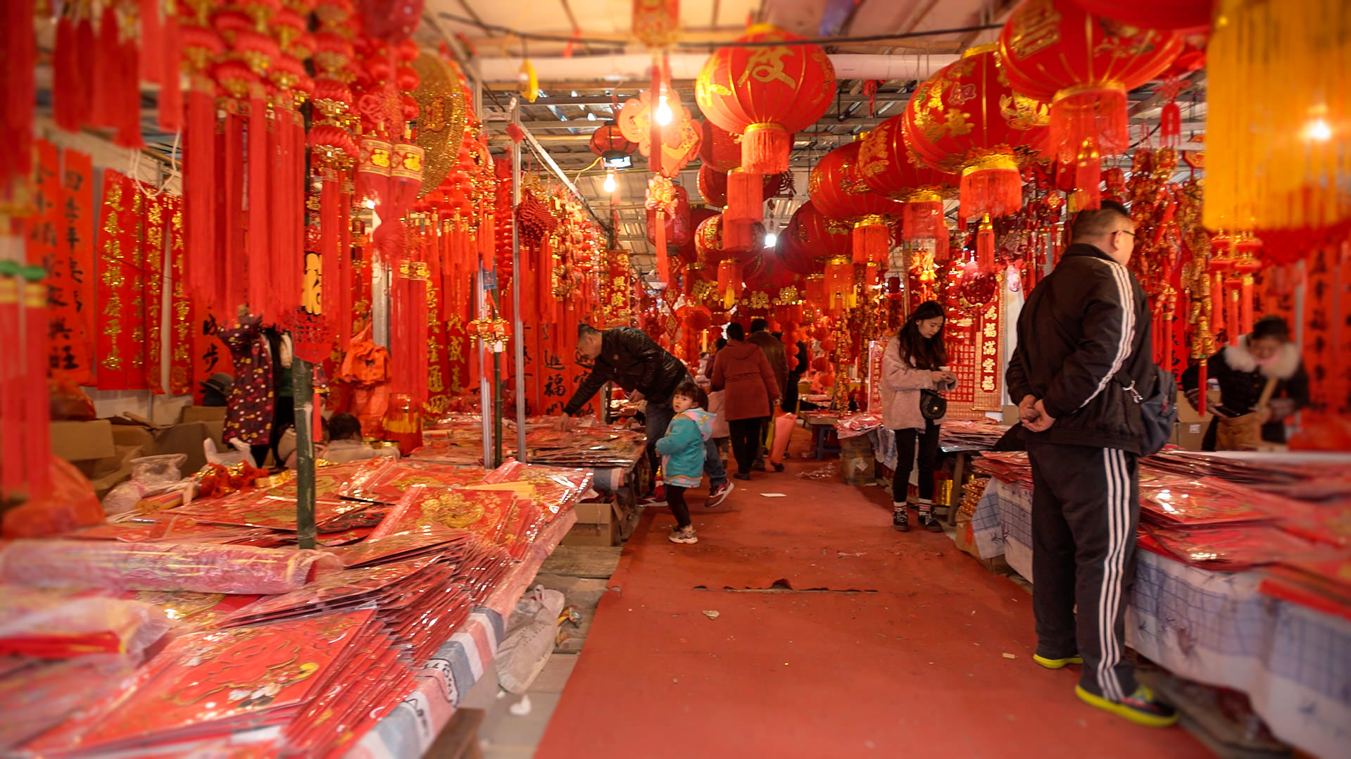 The gateway to Chinese New Year Red Chinese New Year decorations plaster every wall of this underground market